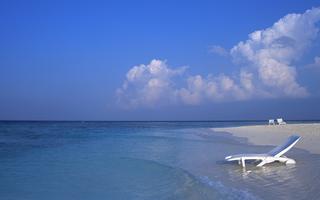 A Deck Chair in the Water on a Maldives Beach 8:5