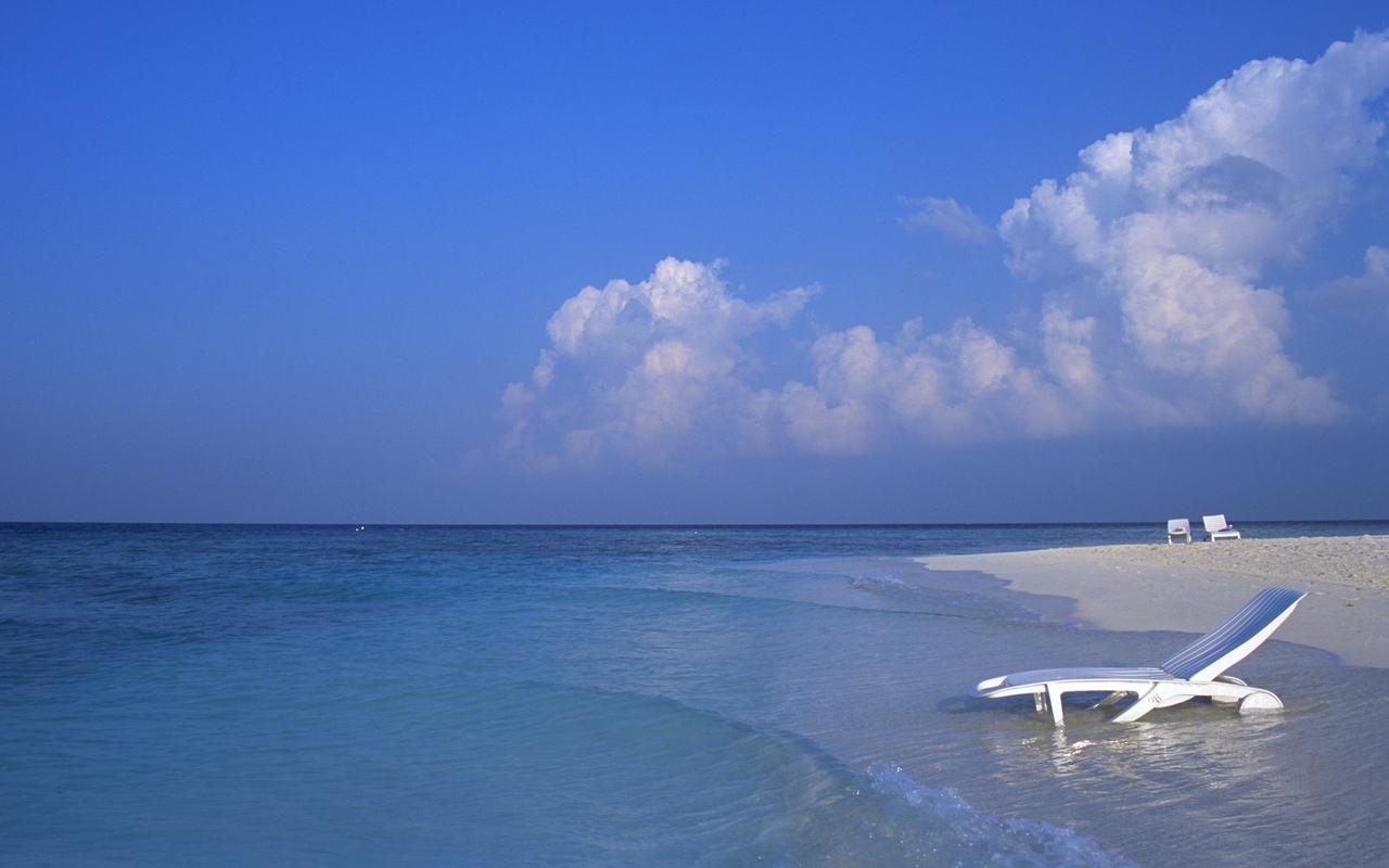 A Deck Chair in the Water on a Maldives Beach 8:5